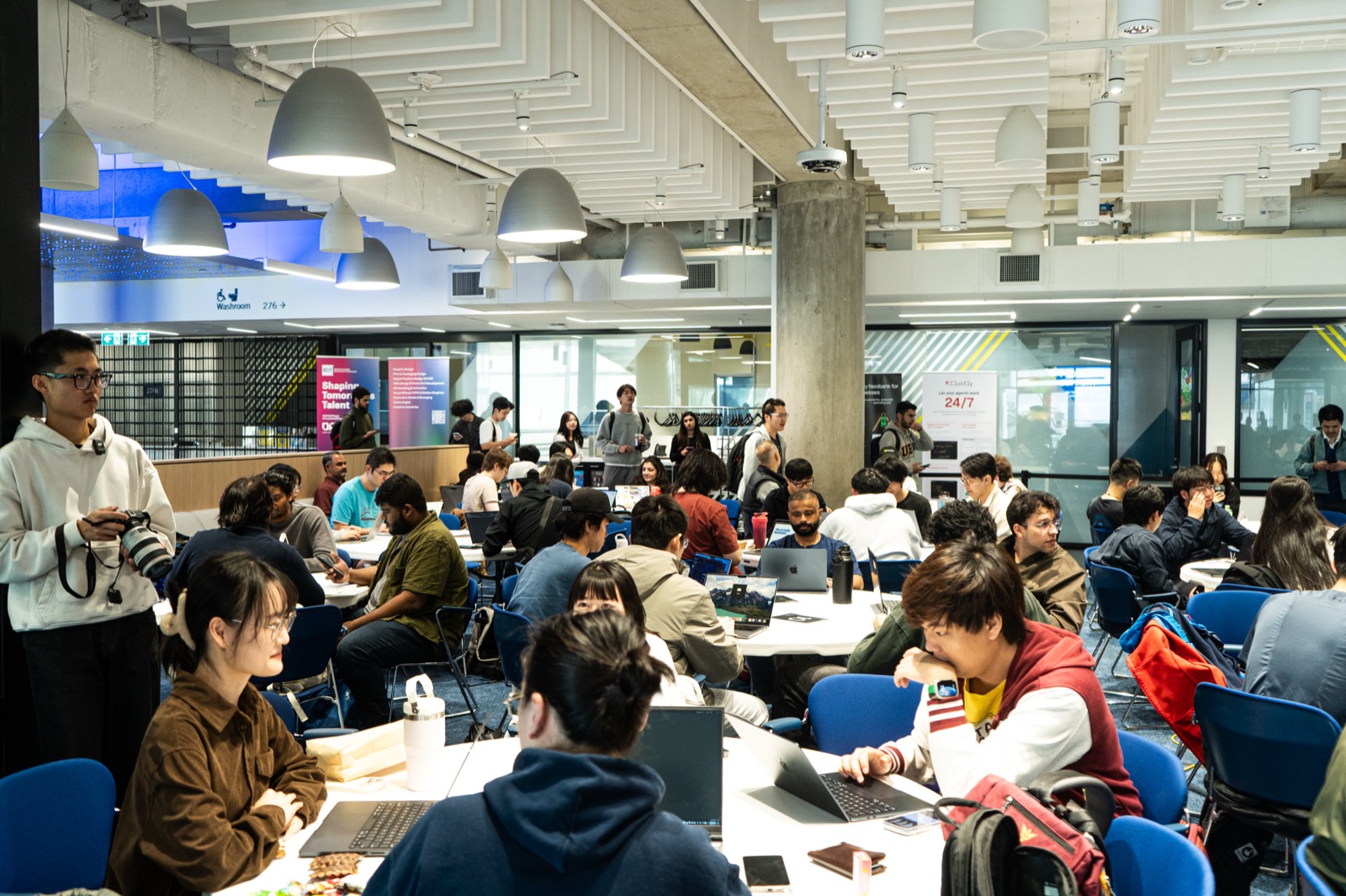 Teams heads-down building at their tables during the hackathon